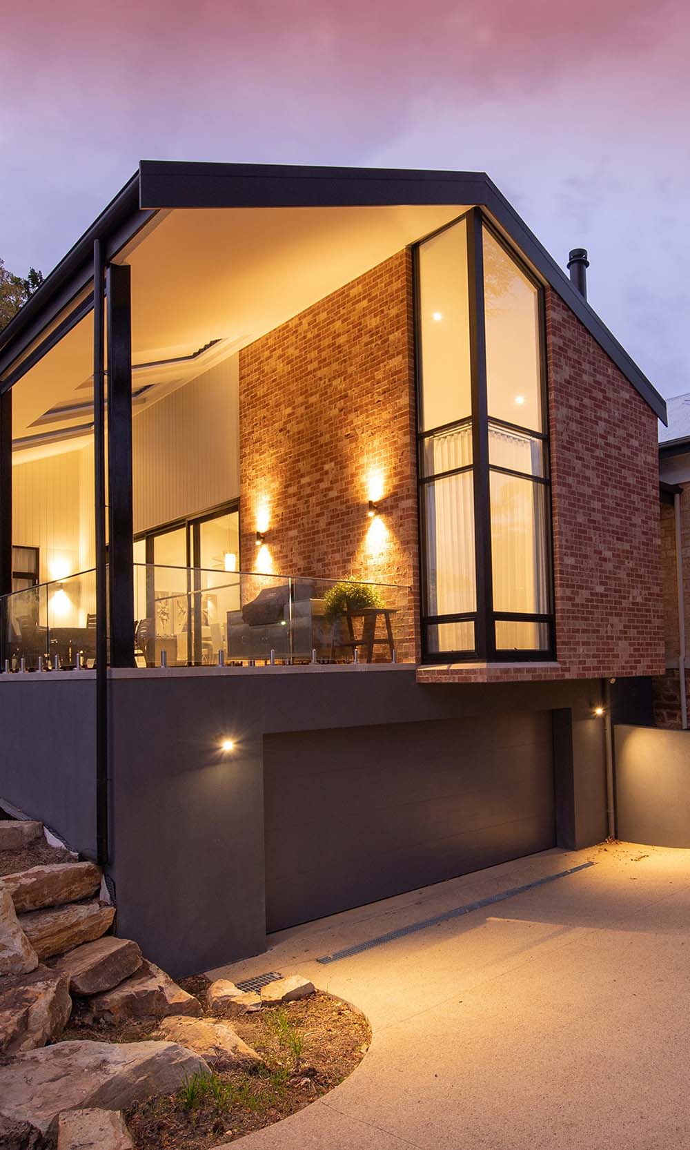 Front area of a house with lighted stairs and patio